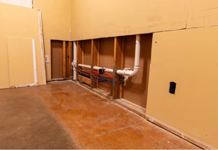 drywall-needing-repair Wood kitchen cabinets partially refinished to light gray, showing a before-and-after transformation by Red Door Painting Pros in Tucson.